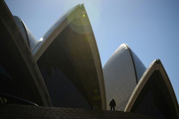 Tourists walk outside the Sydney Opera House on May 10, 2017
