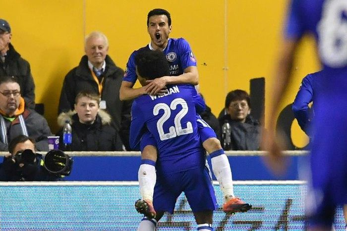Chelsea's Spanish midfielder Pedro (top) celebrates with teammate Willian after scoring the opening goal of their English FA Cup fifth round match against Wolverhampton Wanderers on February 18, 2017