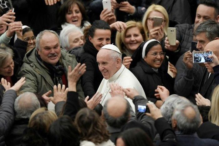 Pope Francis shakes hands during an audience at the Vatican with people struck by the Italian earthquakes on January 5, 2017