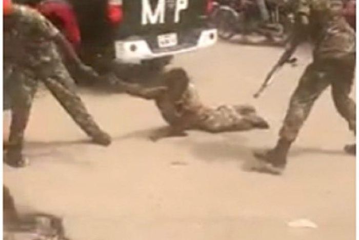 The soldiers assaulting the crippled man