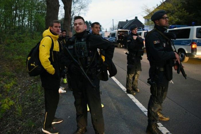 Police escort Dortmund's players, including defender, Sven Bender after an explosion broke windows on the team bus some 10km away from the stadium prior to a Champions League football match against Monaco in Dortmund, Germany April 11, 2017