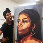 Artist beside the Michelle Obama portrait