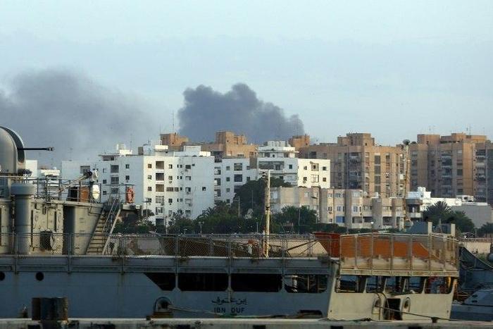 Smoke rises in the centre of the Libyan capital of Tripoli after the clashes on May 26, 2017