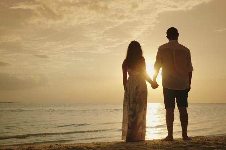 Stock photo of a couple's silhouette on a beach [Credit - Shutterstock]