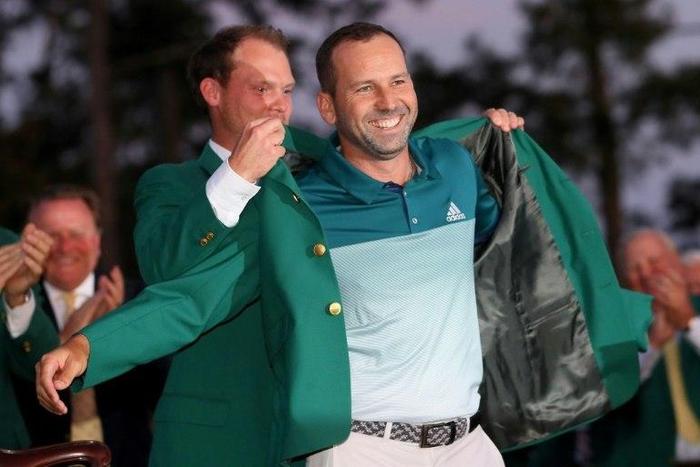 Danny Willett of England presents Sergio Garcia of Spain with the green jacket after Garcia won in a playoff during the final round of the 2017 Masters tournament, at Augusta National Golf Club in Georgia, on April 9