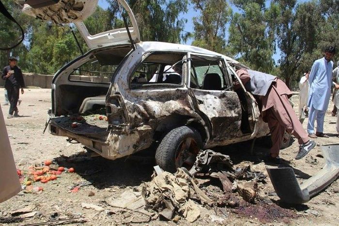 Afghan residents gather at the scene of a suicide car bomb that targeted a CIA-funded pro-government militia force at a public bus station in Khost province on May 27, 2017