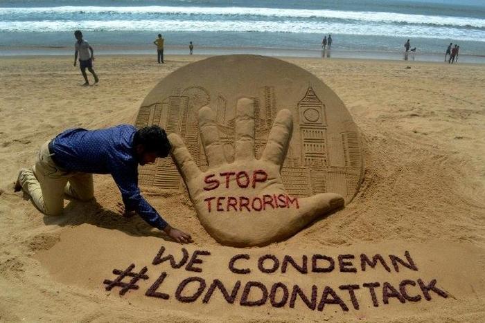 Indian sand artist Sudarsan Pattnaik creates a sculpture on Puri Beach on the Bay of Bengal the day after the London attack