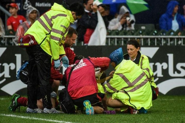 Germany's Sam Rainger (back, bottom C) is bandaged after sustaining a head injury during their match against Hong Kong on the third day of the Hong Kong Rugby Sevens tournament on April 10, 2016