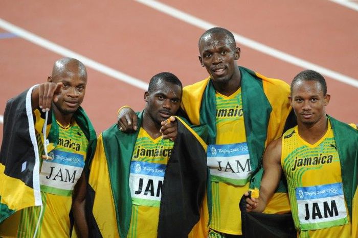 (L-R) Jamaica's Asafa Powell, Nesta Carter, Usain Bolt and Michael Frater celebrating after winning the men's 4×100m Relay final at the National Stadium in Beijing during the 2008 Olympic Games