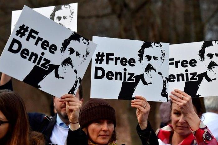 People hold placards with hashtag #FREEDENIZ to protest the detantion of German journalist Deniz Yucel in front of Turkish embassy in Berlin on February 28, 2017