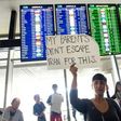 Protesters hold signs up during a protest at San Francisco International Airport in California on January 29, 2017