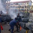 Officials remove dead bodies from a bomb blast scene in Maiduguri, Borno State.