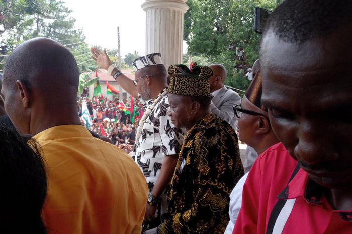 IPOB leader, Nnamdi Kanu waves at Biafran protesters in front of his Umuahia home on Wednesday, June 28, 2017