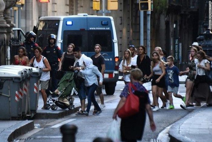 People flee the scene of the attack which occurred in Barcelona, Spain, on August 17, 2017.