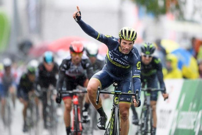 Switzerland's Michael Albasini of Team Orica-Scott (C) recats as he crosses the finish line to win the first stage of Tour de Romandie UCI protour cycling race, a 173km ride from Aigle to Champery on April 26, 2017