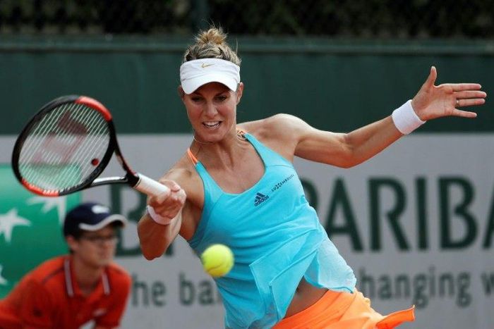 Luxembourg's Mandy Minella returns the ball to Belgium's Kirsten Flipkens during their match at the 2017 French Open at Roland Garros in Paris on May 29, 2017