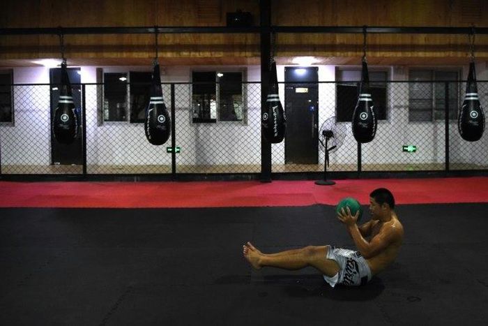 Chinese mixed martial arts (MMA) fighter Li Jingliang trains at a gym in Beijing
