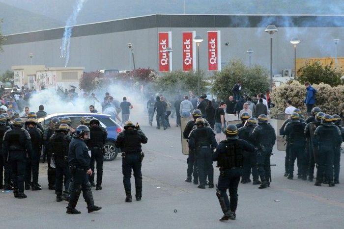 French anti-riot policemen scatter Bastia's supporters outside the stadium after the French L1 football match Bastia (SCB) vs Lyon (OL) on April 16, 2017 in the Armand Cesari stadium in Bastia on the French Mediterranean island of Corsica