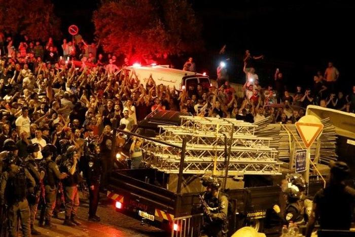 Palestinians celebrate outside the Al-Aqsa mosque compound on July 27, 2017, after more new Israeli security barriers were removed from the entrance
