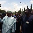 Presidential media aides, Femi Adesina and Garba Shehu speak to protesters at the Presidential Villa on August 17, 2015.