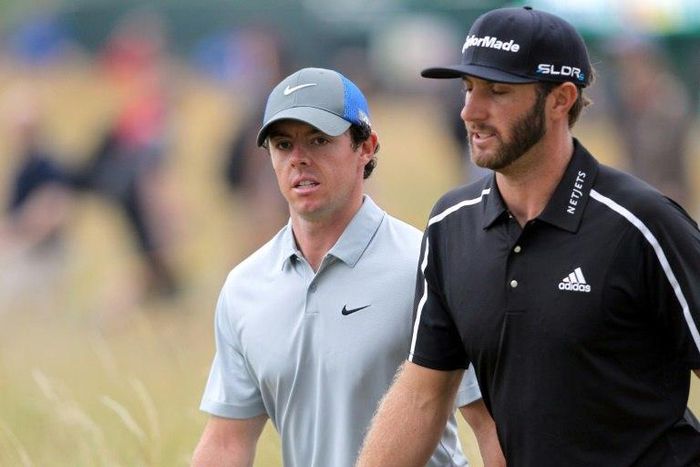 Dustin Johnson (R) and Rory McIlroy (L) will play together at the British Open with former Masters champion Charl Schwartzel of South Africa when the opening round gets underway at 2:48pm (1348 GMT) Thursday