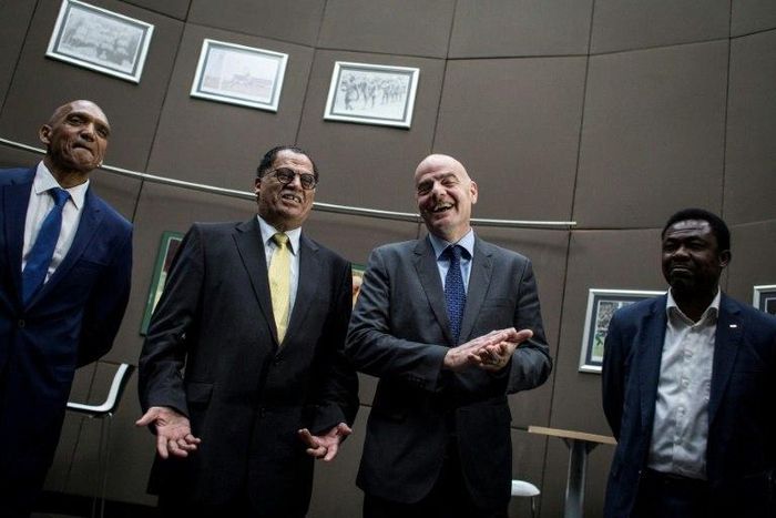 FIFA President Gianni Infantino (2nd R) laughs next to President of the South African Football Association Danny Jordaan (2nd L) during a visit to the South African Football Association (SAFA) House in Soweto on February 21, 2017