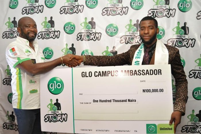 Winner of the Mr. Glo Campus Data Dude, Ogbuefi Pascal (right) being presented with a cheque by Globacom’s Head of Operations, South South, Mr. Nwachukwu Aja after winning the coveted prize during the Glo Campus Storm music concert at the Enugu Campus ...