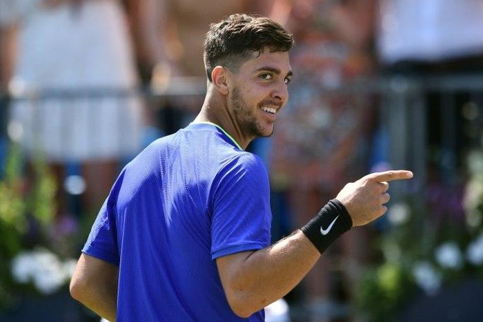 Australia's Thanasi Kokkinakis celebrates beating Canada's Milos Raonic at Queen's Club in west London on June 20, 2017