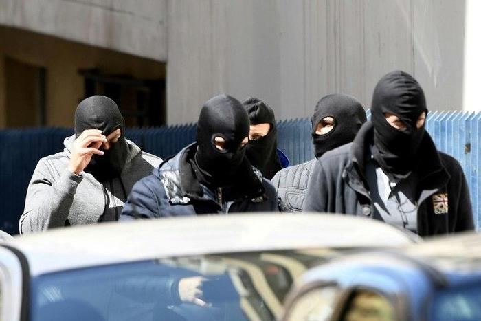 Police found guns, explosives and an IS flag at the suspects' flat