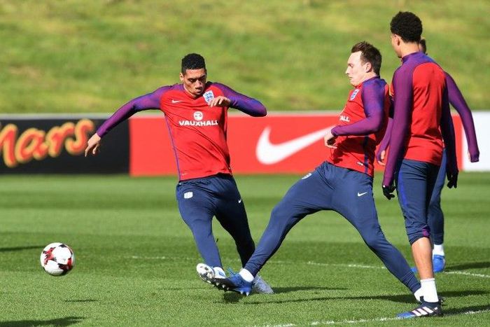 England defender Chris Smalling (L) and teammate Phil Jones take part in a training session at St George's Park in Burton-on-Trent, central England on March 21, 2017