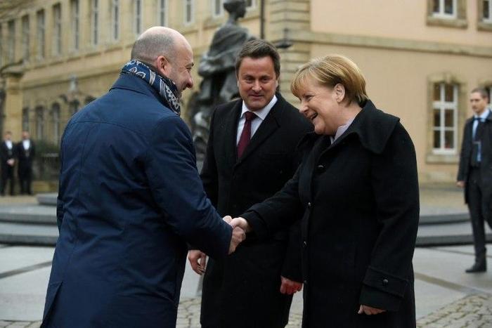Luxembourg's Prime minister Xavier Bettel (C) and Deputy Prime Minister Etienne Schneider welcome German Chancellor Angela Merkel (R) during a visit in Luxembourg on January 12, 2017