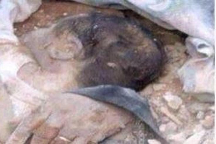 The buried baby being rescued