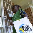 Volunteer Health officials wait to immunise children at a school in Nigeria's capital Abuja.