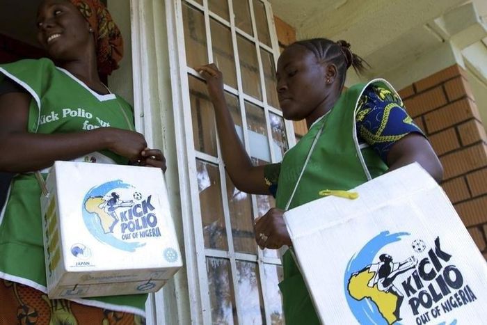 Volunteer Health officials wait to immunise children at a school in Nigeria's capital Abuja.