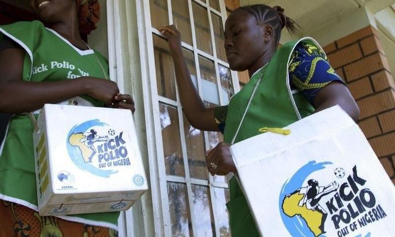 Volunteer Health officials wait to immunise children at a school in Nigeria's capital Abuja.