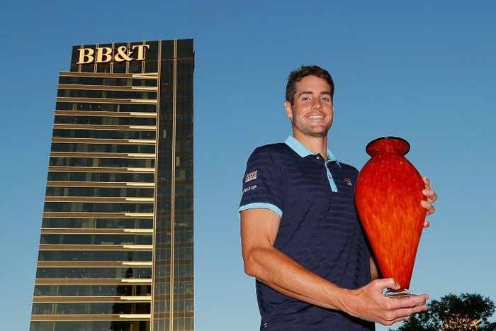 John Isner of the US poses with the trophy after winning the BB&T Atlanta Open, on July 30, 2017