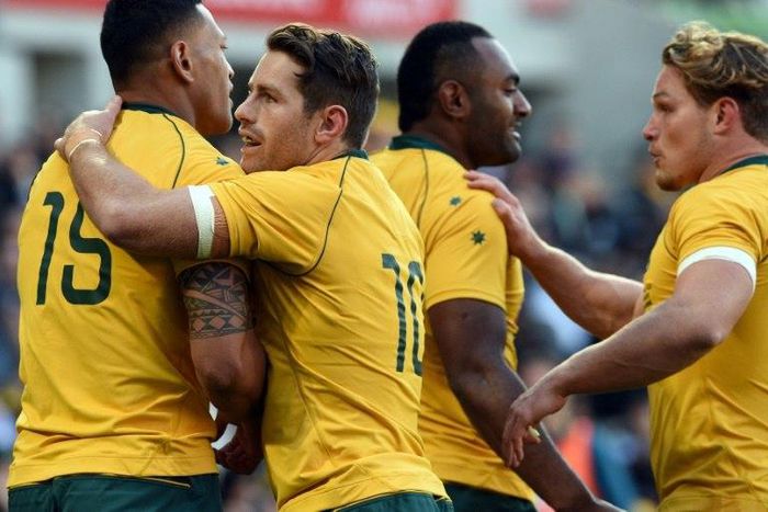 Australia's Israel Folau is congratulated by teammates after successful try during their rugby union Test match against Fiji, in Melbourne, on June 10, 2017