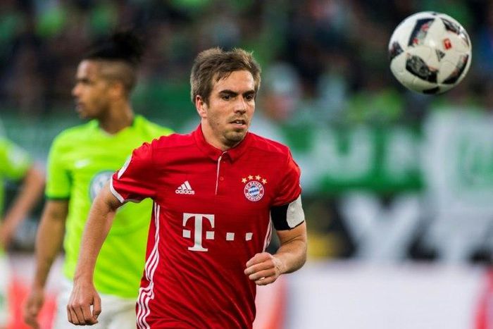 Bayern Munich's defender Philipp Lahm runs with the ball during the German first division Bundesliga football match between VfL Wolfsburg and Bayern Munich on April 29, 2017