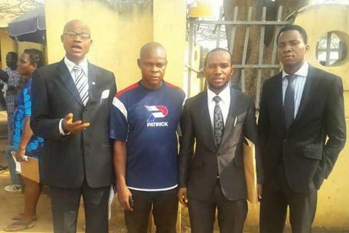 Joachim Ike surrounded by his lawyers