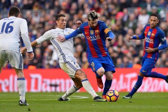Barcelona's forward Lionel Messi (2ndR) vies with Real Madrid's forward Cristiano Ronaldo during the Spanish league football match at the Camp Nou stadium in Barcelona on December 3, 2016