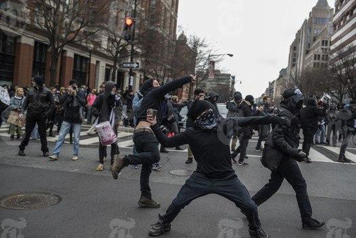 A rioter throws a rock during a protest on inauguration day, in Washington, Jan. 20, 2017. With far-right groups edging into the mainstream with the rise of President Donald Trump, self-described “anti-fascists” and anarchists are vowing to confront th...