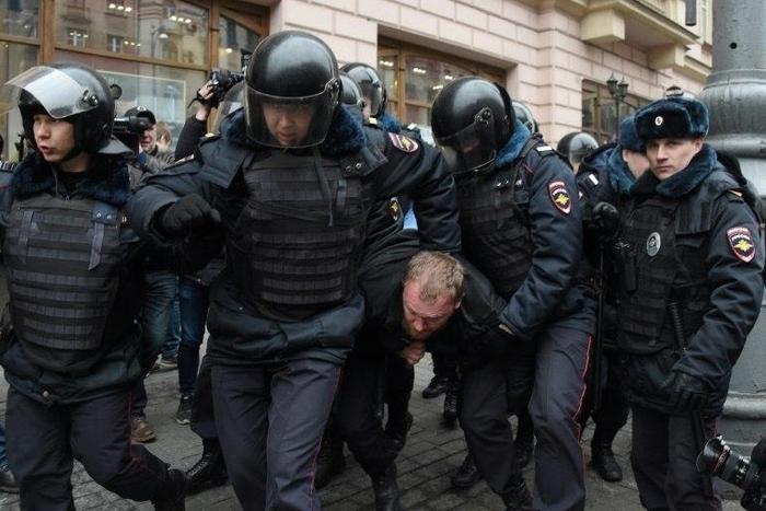 Russian police officers detain a man in central Moscow on April 2, 2017, as Russian opposition promised protests after police detained hundreds of people during anti-corruption rallies