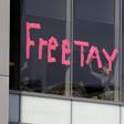 A makeshift sign goes up in an office window across from a courthouse where pop singer Taylor Swift is being sued for slander by a Denver DJ who she says groped her