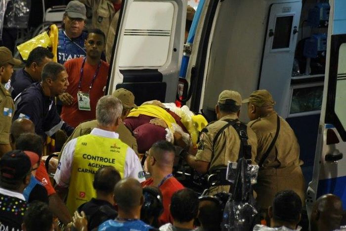 A woman is carried into an ambulance after being struck by the Paraiso do Tuiuti samba school float at the entrance of the Sambadrome during the first night of the Rio Carnival on February 26, 2017
