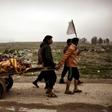 Relatives transport the bodies of west Mosul residents allegedly killed in an airstrike targeting Islamic State group jihadists on March 17, 2017