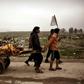 Relatives transport the bodies of west Mosul residents allegedly killed in an airstrike targeting Islamic State group jihadists on March 17, 2017