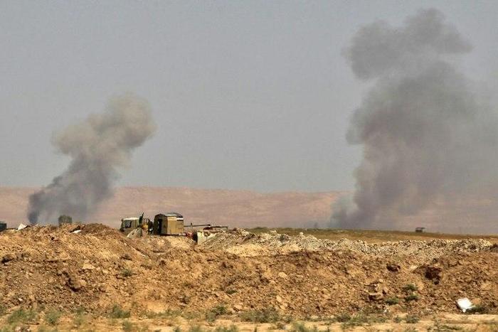 Smoke billows as Iraqi forces, backed by Shiite fighters from the Popular Mobilisation Forces, advance towards the city of Tal Afar, a key remaining stronghold of the Islamic State group, on August 21, 2017