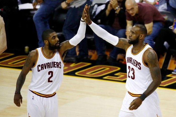 Kyrie Irving (L) and LeBron James of the Cleveland Cavaliers high five against the Golden State Warriors in Game 4 of the 2017 NBA Finals at Quicken Loans Arena on June 9, 2017 in Cleveland, Ohio