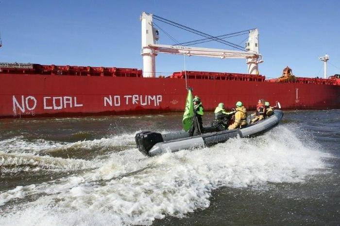 Activists of Greenpeace have painted 'No Coal No Trump' on the side of the 'SBI Subaru' ship with some 60,000 tons of coal from Texas on board in Hamburg, nothern Germany on June 1, 2017