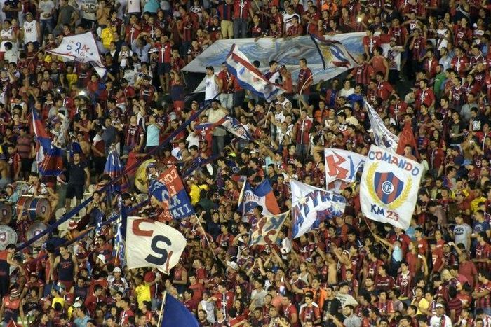 Fans of Paraguay's Cerro Porteno cheer for their team during their Copa Libertadores 2016 football match against Colombia's Independiente de Santa Fe at Defensores del Chaco stadium in Asuncion, on April, 20, 2016